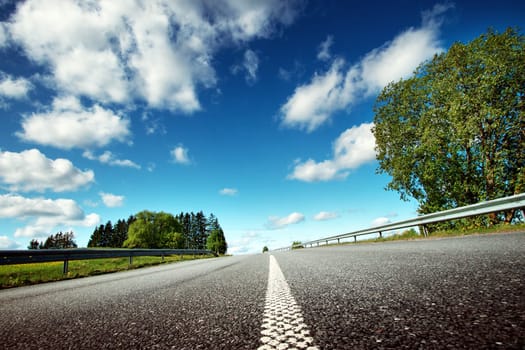 Car on asphalt road in beautiful spring day at countryside