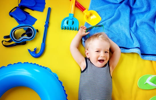 little boy with sunglasses on yellow blanket