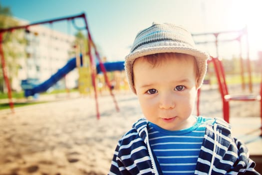 Little boy playing on playground in the spring
