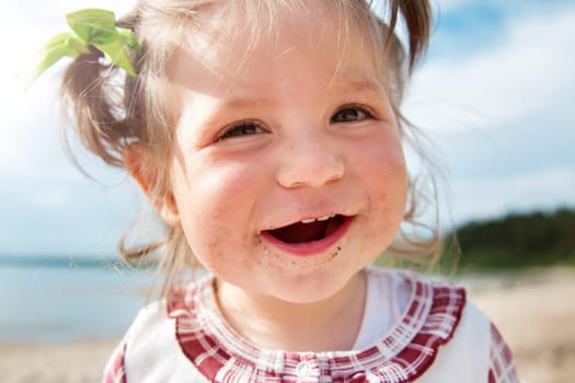 Funny one year old girl shouting at the sea