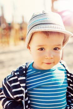 Little boy playing on playground in the spring