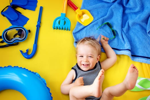 little boy with sunglasses on yellow blanket
