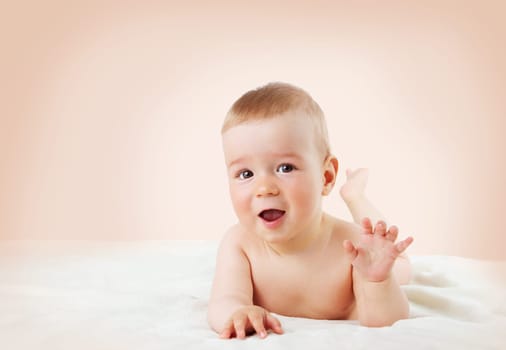 cute eight month old baby lying on soft blanket at home