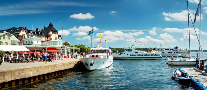 VAXHOLM, SWEDEN - JUNE 25, 2016: Cruise boats at little cosy island Vaxholm near Stockholm