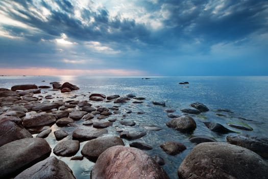 Rocky shores at the sea in sunset light. Lahemaa natural park coastal landscape with beautiful sky