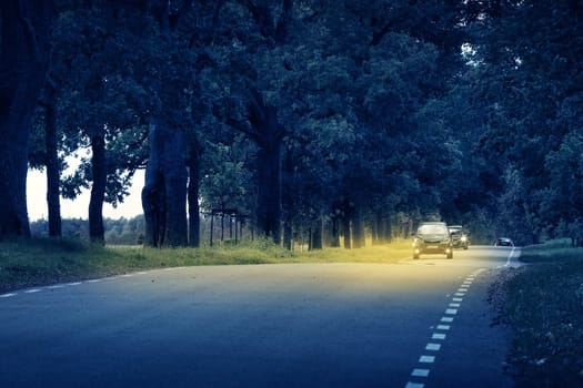 Cars moving on the road at night in summer