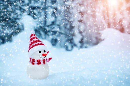 little snowman on soft snow in the forest in winter