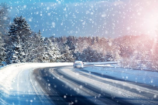 Car tires on winter road covered with snow