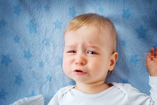 One year old baby crying in bed