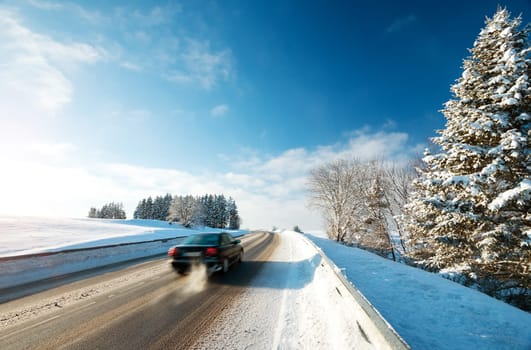 Car tires on winter road covered with snow