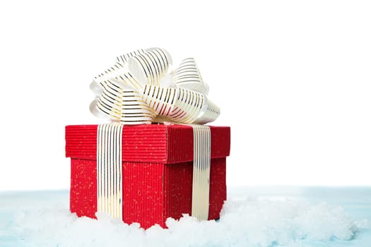 Red gift box on snow on white background