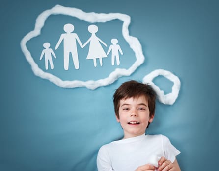 seven years old boy dreaming of a family on blue background