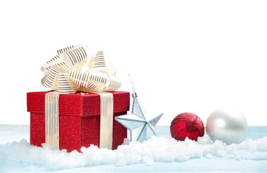 Red gift box on snow on white background