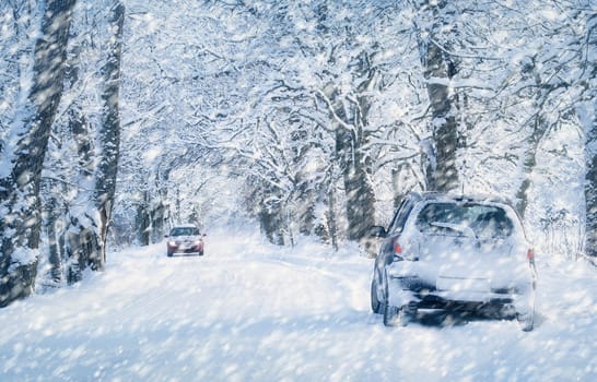 Car tires on winter road covered with snow. Vehicle on snowy alley in the morning at snowfall