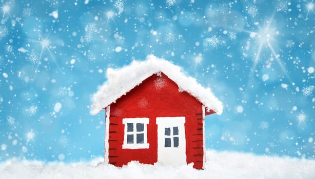 Small red house model covered with snow in winter