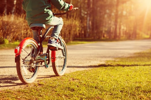child on a bicycle at asphalt road