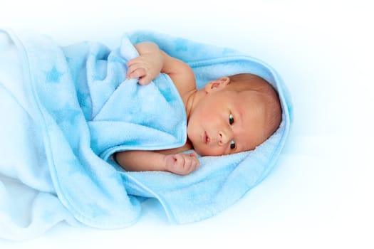 One week old baby in a blanket on white background