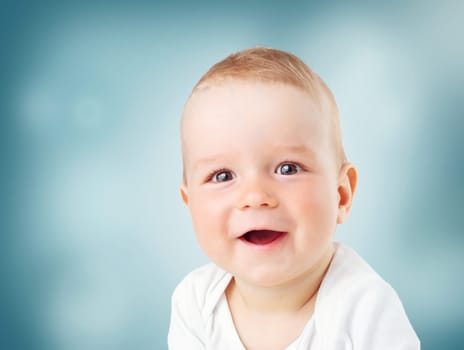Portrait of nine month old baby. Pretty smiling little child