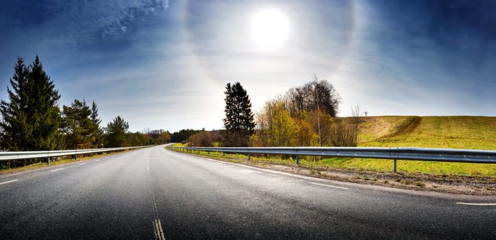 asphalt road panorama in countryside on sunny spring evening