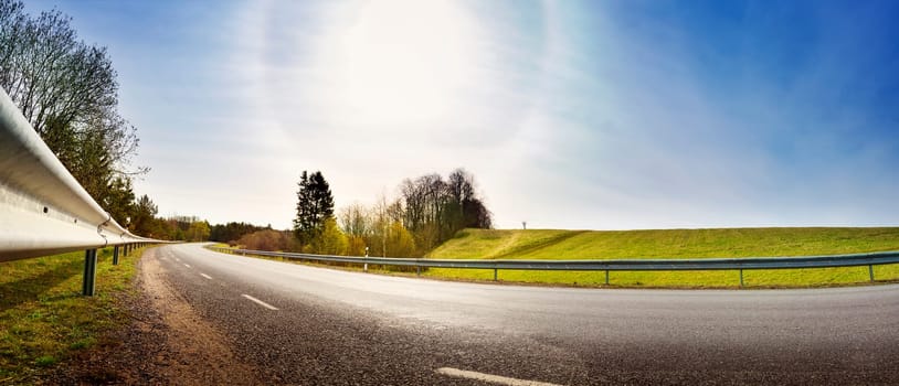 asphalt road panorama in countryside on sunny spring evening
