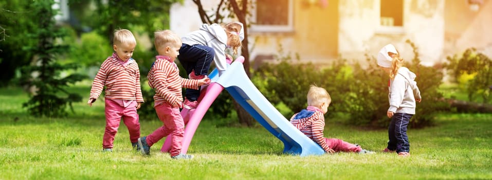 Boy and boy playing on the backyard on sliding