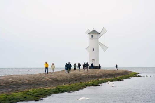 Holidaymakers at the Muhlenbake, the landmark of Swinoujscie on the Polish Baltic coast