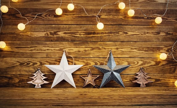 Old wooden planks with christmas decoration. Brown background with stas