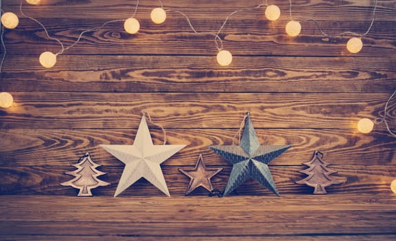 Old wooden planks with christmas decoration. Brown background with stas