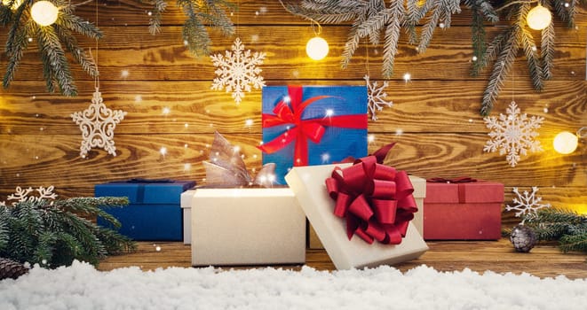 Old wooden planks with christmas decoration. Brown background with gift boxes, candles, stars and snow