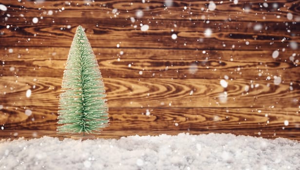 Old wooden planks with christmas trees. Brown background with snow and snowflakes
