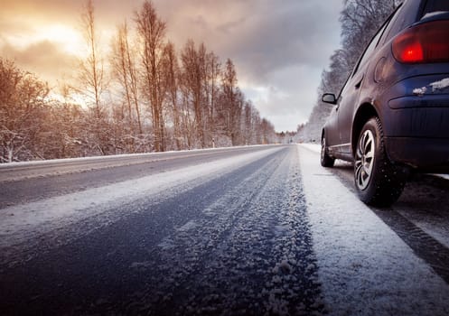 car on winter road in the morning