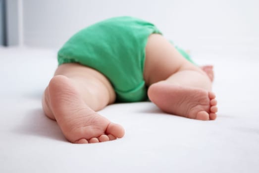 Baby feet on white background with blue blanket