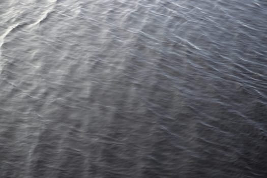 4 - Abstract background water texture, gentle and smooth water ripples. Outdoors reservoir lake, in natural daylight condition. Full frame image
