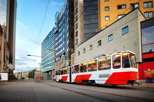 View to Tallinn in late evening in summer. Estonian capital. City landscape with tram on the road and modern buildings