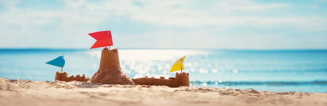 Sandcastle on the sea in summertime. Seashore on beautiful day