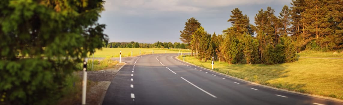 asphalt road view in countryside at beautiful sunset