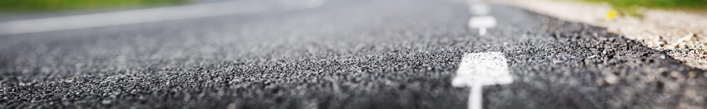 black asphalt road and white dividing lines