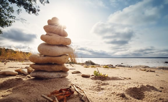 Stacked stones at evening light on the coast