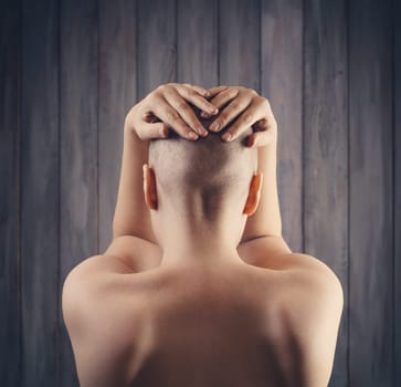 Portrait of a hairless woman from back. Hair growth problems. Bald person with cancer disease