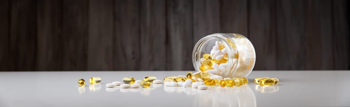 Pills in a jar on wooden background. Drugs in a bottle