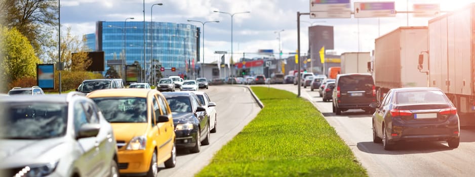 Cars moving on the road in city in late evening. View to the traffic with trafficlights and transport