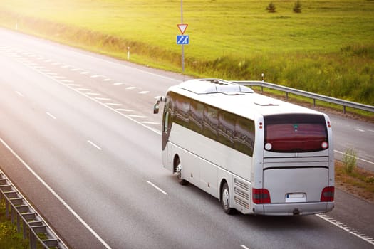 Bus on asphalt road in beautiful summer evening outdoors. Transportation concept. Highway with vehicle
