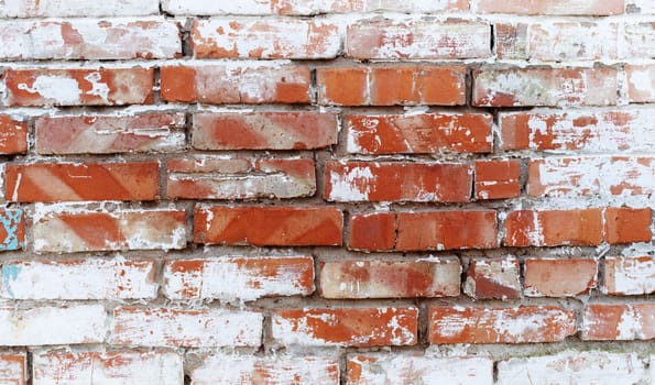 Rustic red brick background with white paint. Dirty wall pattern of an old building. Brickwall texture