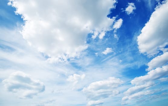 white fluffy clouds on blue sky in summer on sunny day