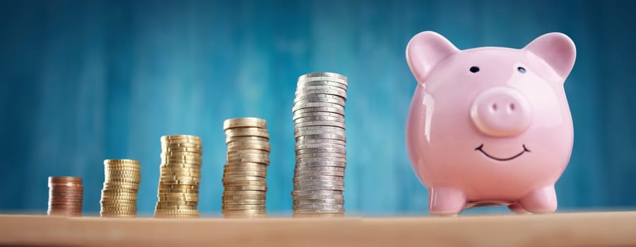 piggy bank with stacked coins. Pig with money savings on blue background