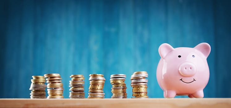 piggy bank with stacked coins. Pig with money savings on blue background