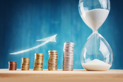 Clock with stacked coins. Pig with money savings and hourglass on blue background