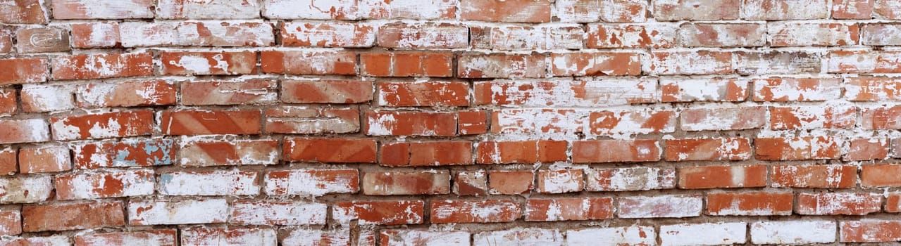 Rustic red brick background with white paint. Dirty wall pattern of an old building. Brickwall texture