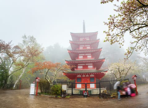 Chureito Pagoda near Fuji mountain at Fujiyoshida in Japan. Temple at Kawaguchiko in Arakura Sengen park on foggy day in spring with cherry blossoms