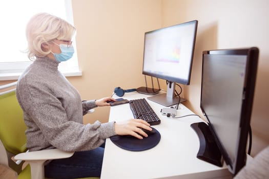 woman working at home in homeoffice. Young businesswoman sitting indoors and using pc